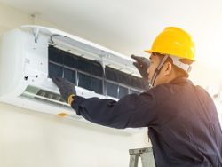 Male Technician Repairing Air Conditioner