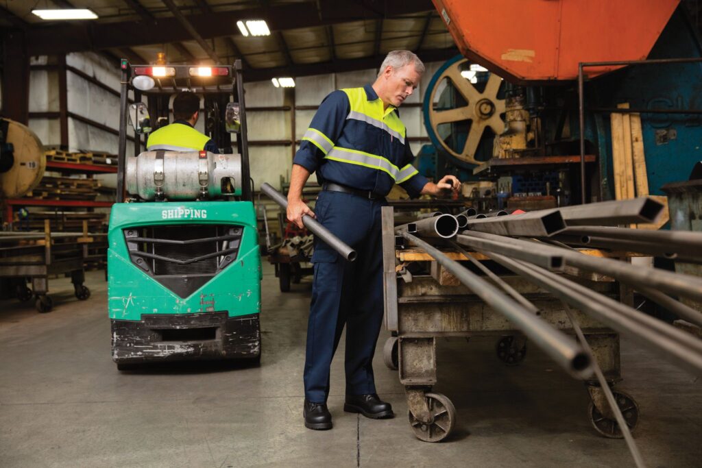 Man Wearing High Visibility Uniform in Industrial Facility